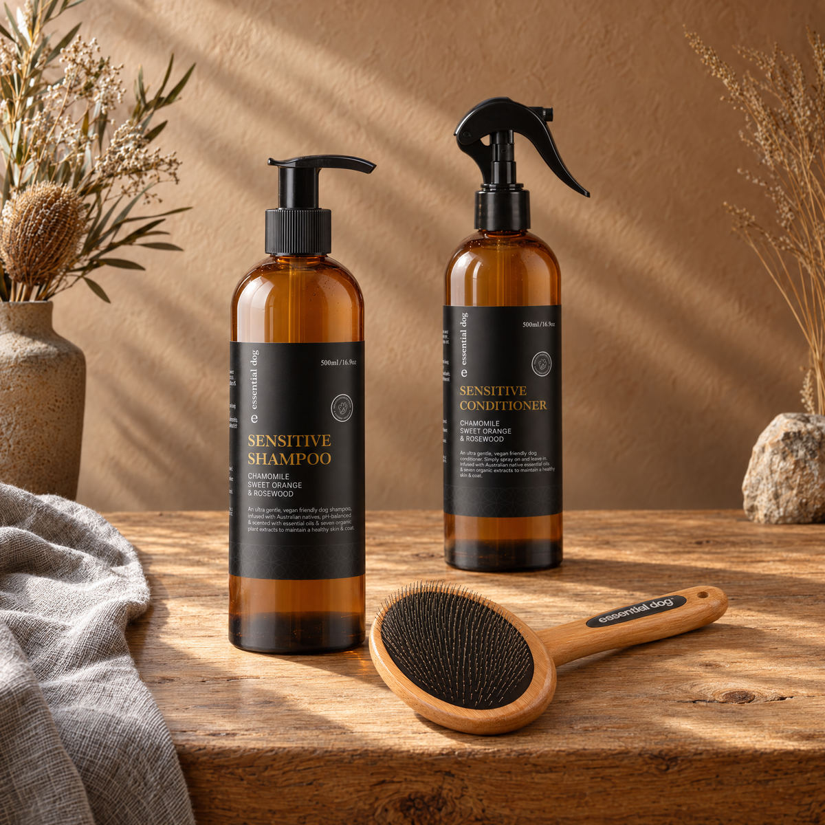 Coat Care Dog Grooming Bundle — 500ml Sensitive Shampoo, Conditioner & Slicker Brush in a grounded editorial tabletop scene with its included selected products.